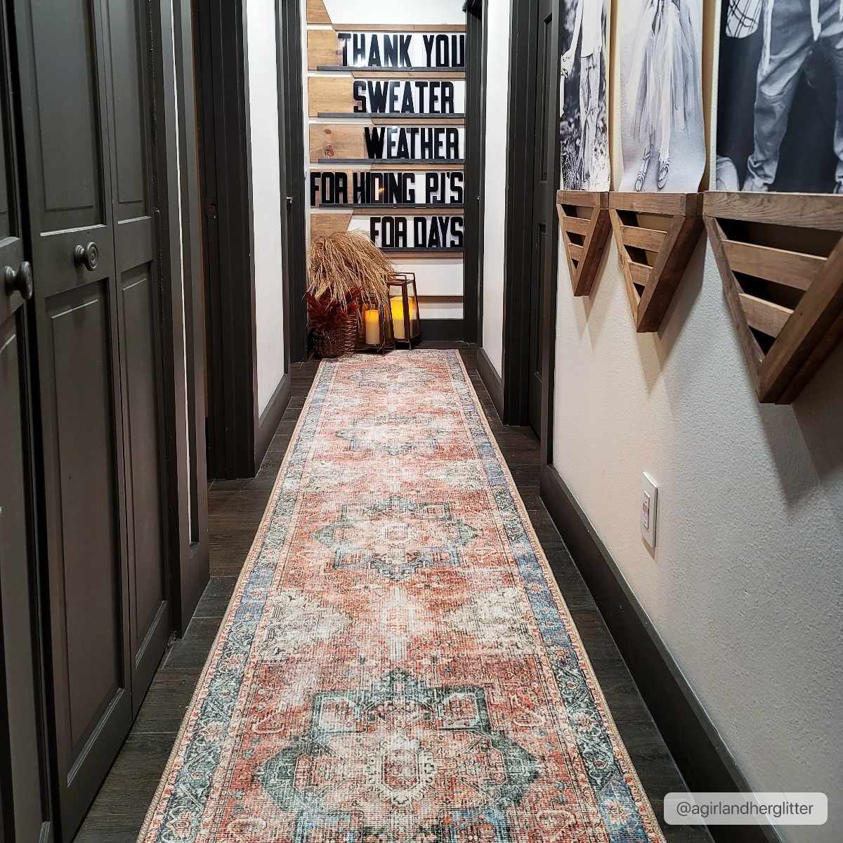 Long, patterned rug in a hallway with decorative elements on the walls.