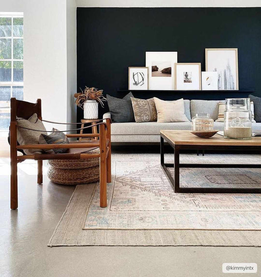 Living room with a gray sofa, wooden coffee table, and decorative pillows.