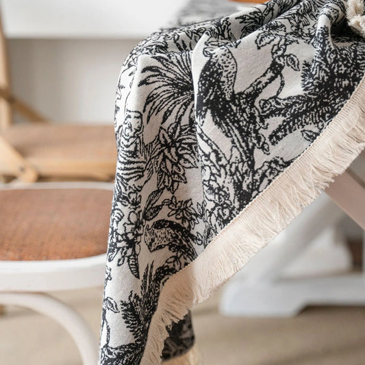 Detail of cotton-blend fringe on black botanical tablecloth