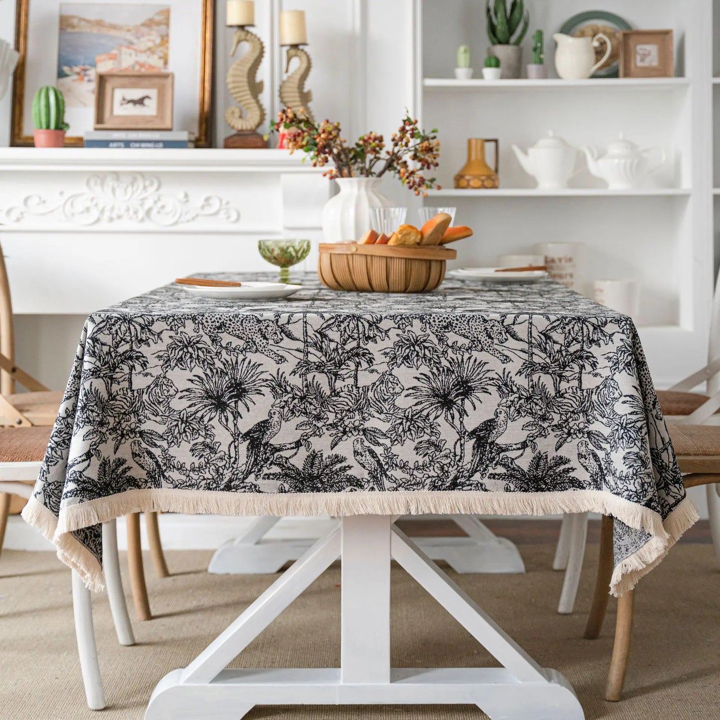Side of black-and-white tropical tablecloth with fringe detail