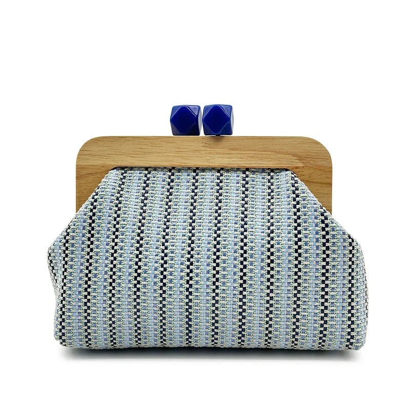blue striped woven clutch with wooden frame and coral clasp, front view