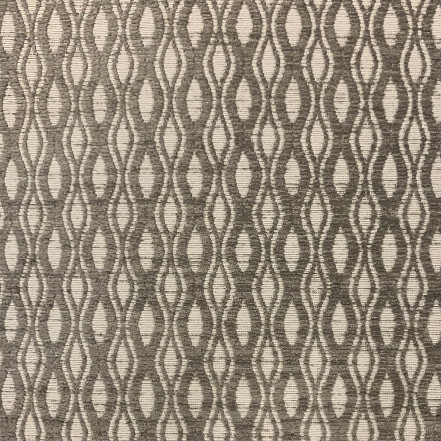 Textured fabric pattern with wavy lines in brown and beige.