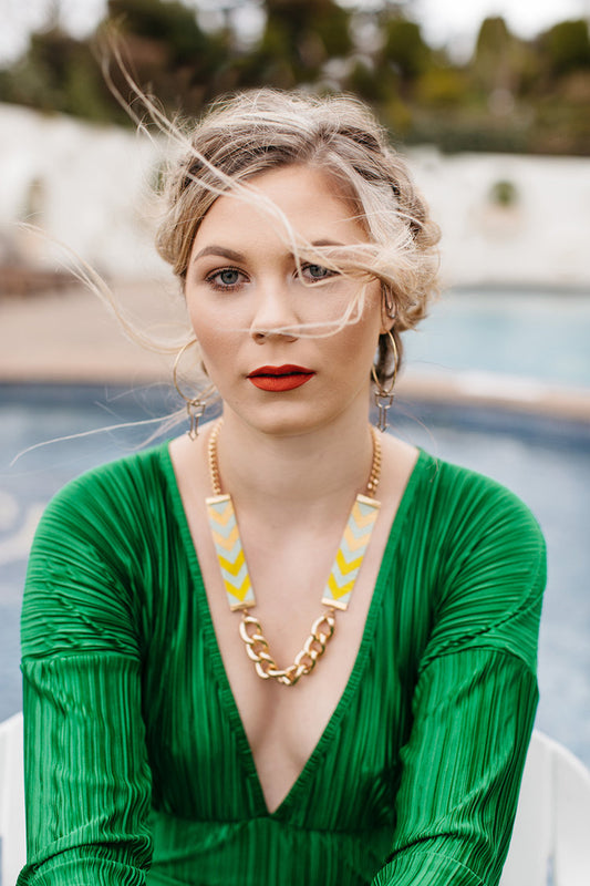 Model wearing Chevron Priestess Necklace in lime and yellow with gold chain