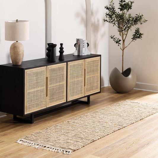 Modern sideboard with rattan doors in a living room setting with jute runner.
