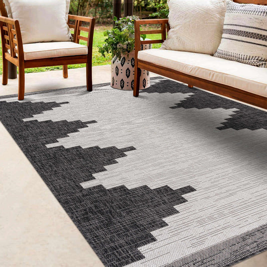 Outdoor rug with geometric pattern on patio with furniture and plants