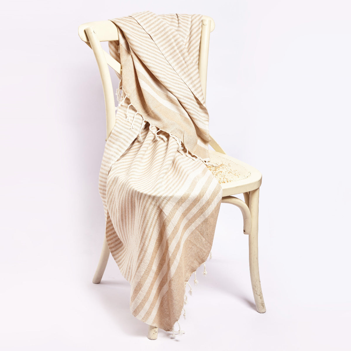 Handwoven eco-friendly cotton blanket in beige with a lightweight, breathable design.