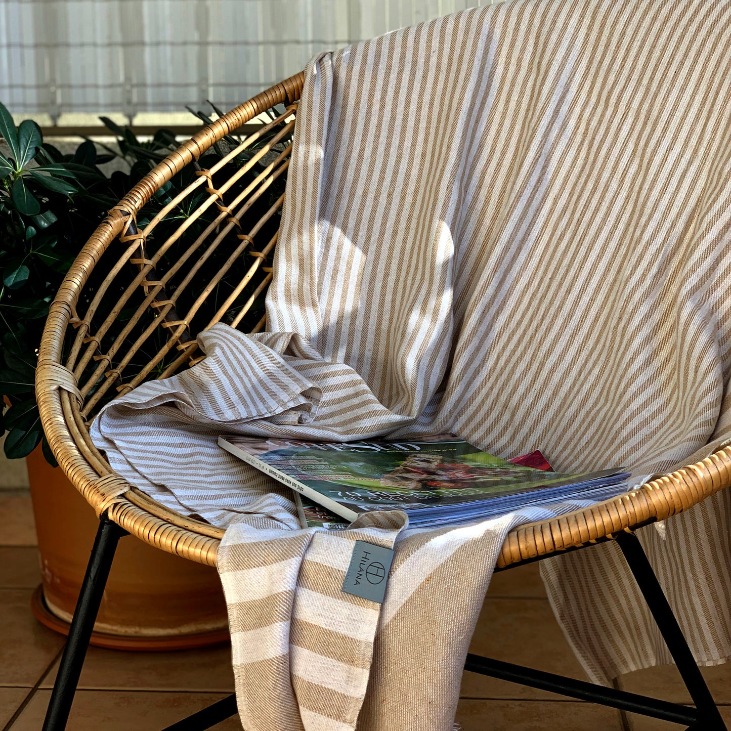 Handwoven eco-friendly cotton blanket in beige with a lightweight, breathable design.