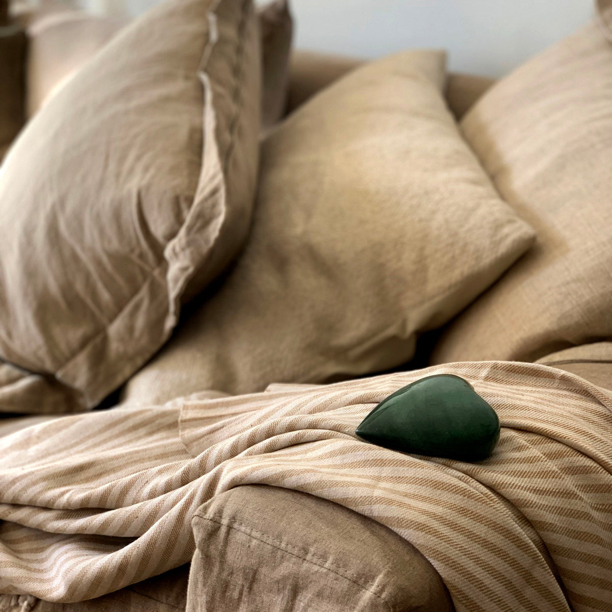 Handwoven eco-friendly cotton blanket in beige with a lightweight, breathable design.