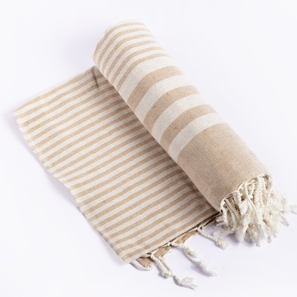 Handwoven eco-friendly cotton blanket in beige with a lightweight, breathable design.