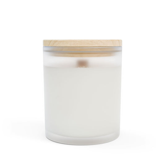 White candle in a glass jar with a wooden lid on a white background