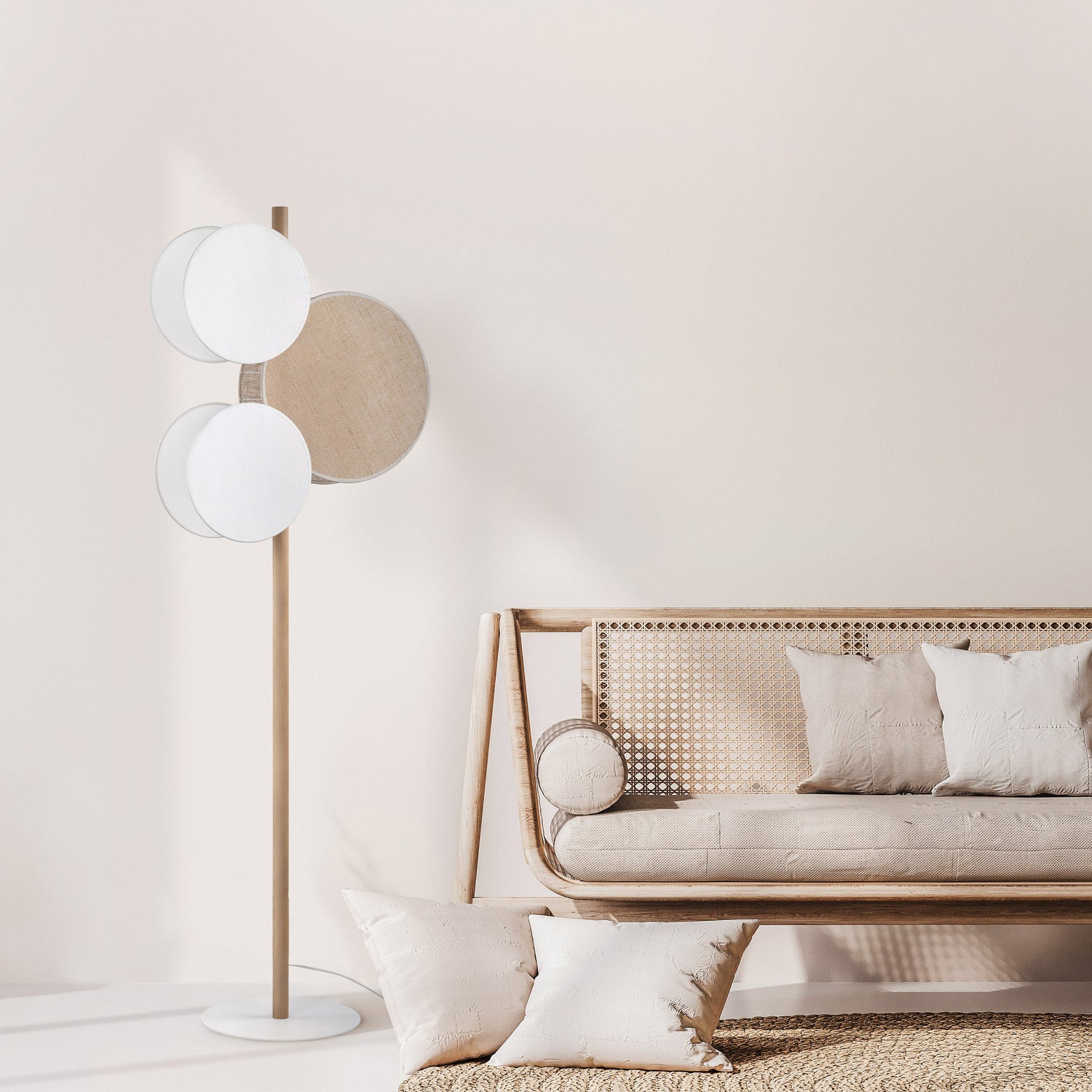 Modern living room with a floor lamp and a sofa against a light wall.