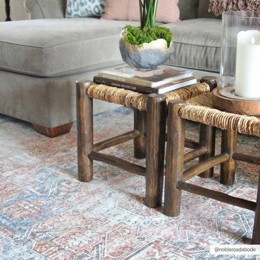 Wooden side tables with woven tops in a living room setting.