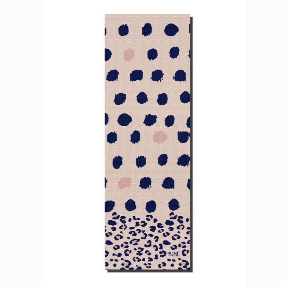 Eco-friendly non-slip yoga mat with a chic navy and blush polka dot design, 5mm thick for extra comfort and stability.