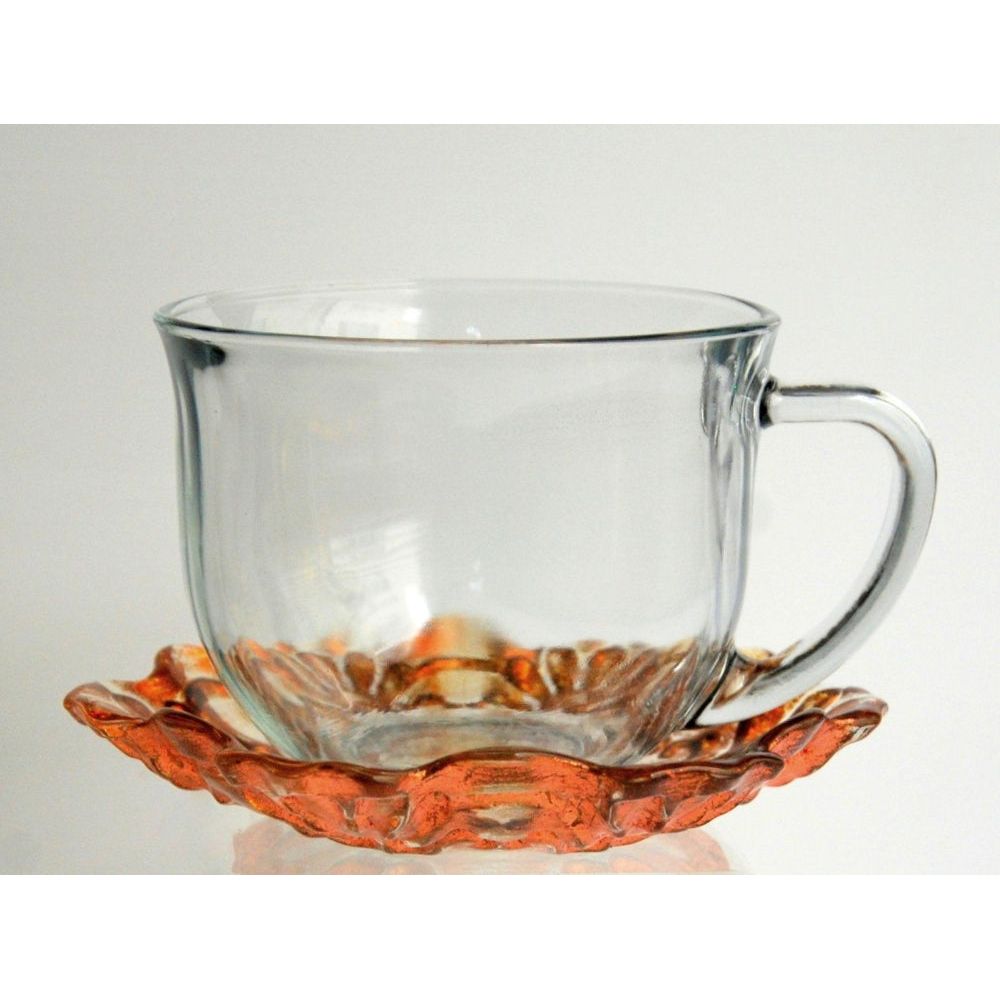 Hand-gilded jumbo cup and saucer set in clear and copper glass, featuring a baroque-inspired lace engraving with a distressed finish.