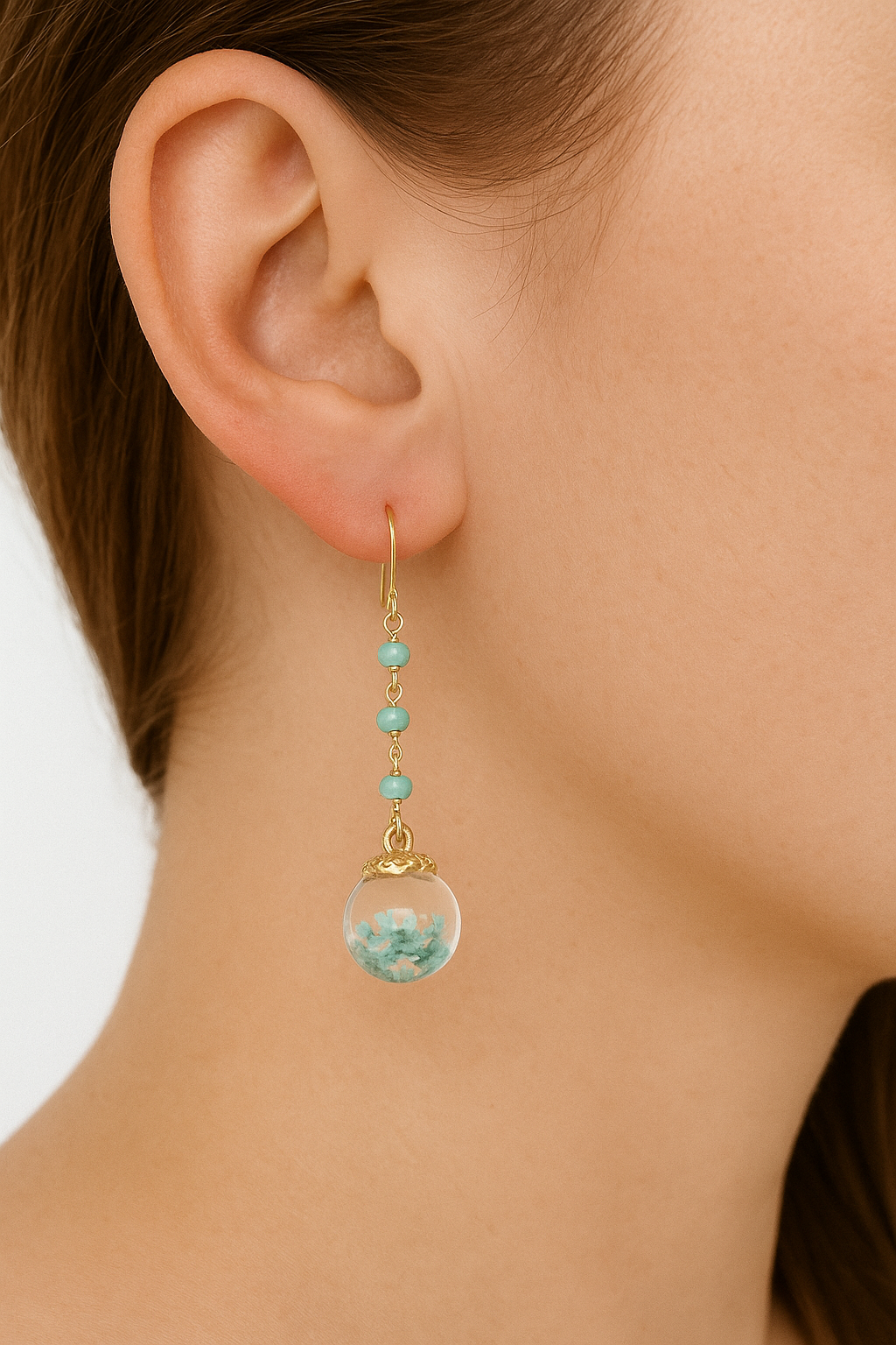 Model wearing petrified flower drop earrings with amazonite and gold