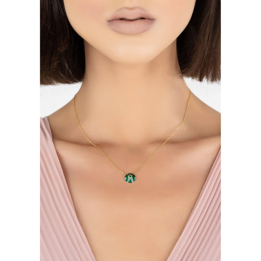 Star of David green enamel necklace in gold worn by a woman, showcasing its refined and meaningful design