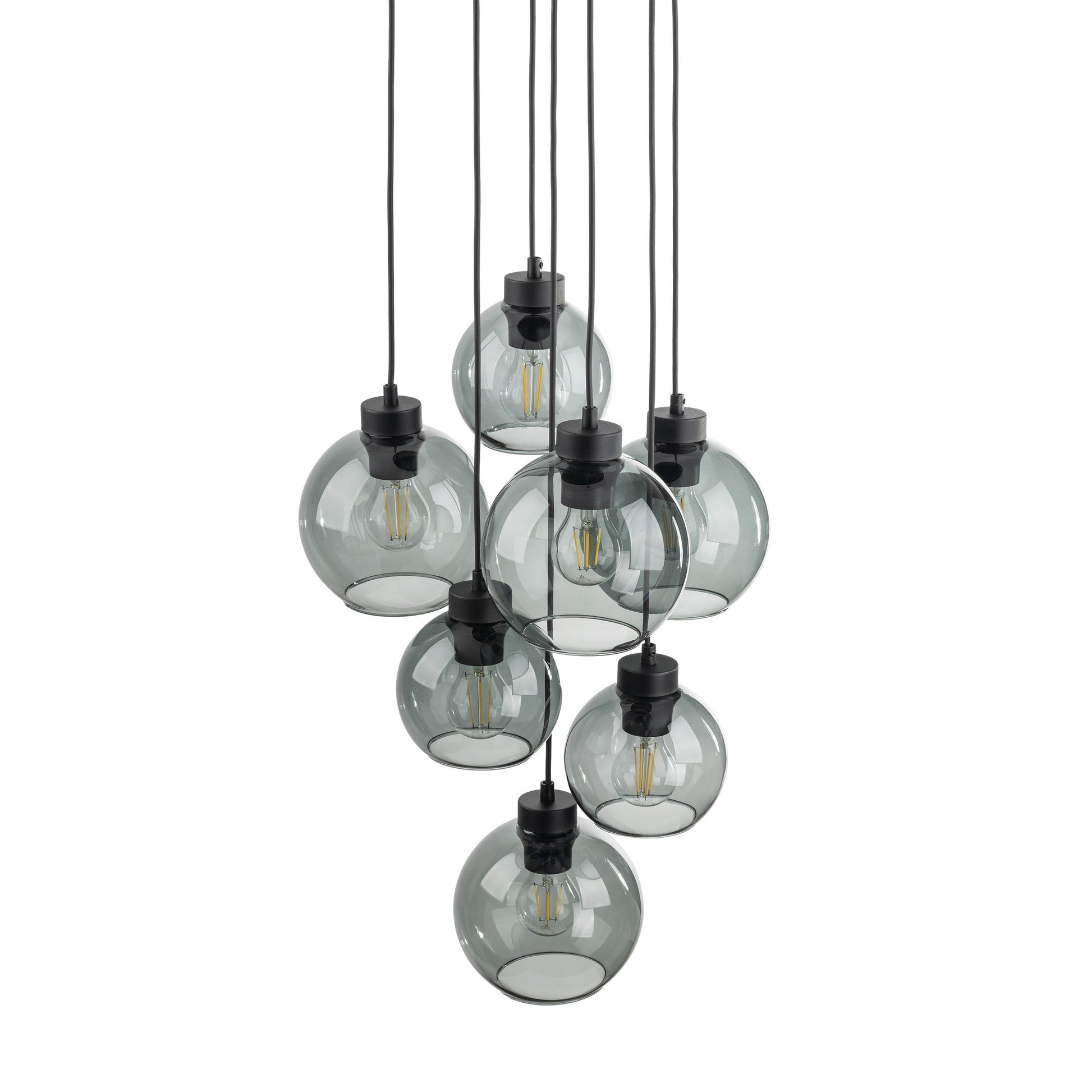 Cluster of hanging pendant lights with clear glass shades on a white background
