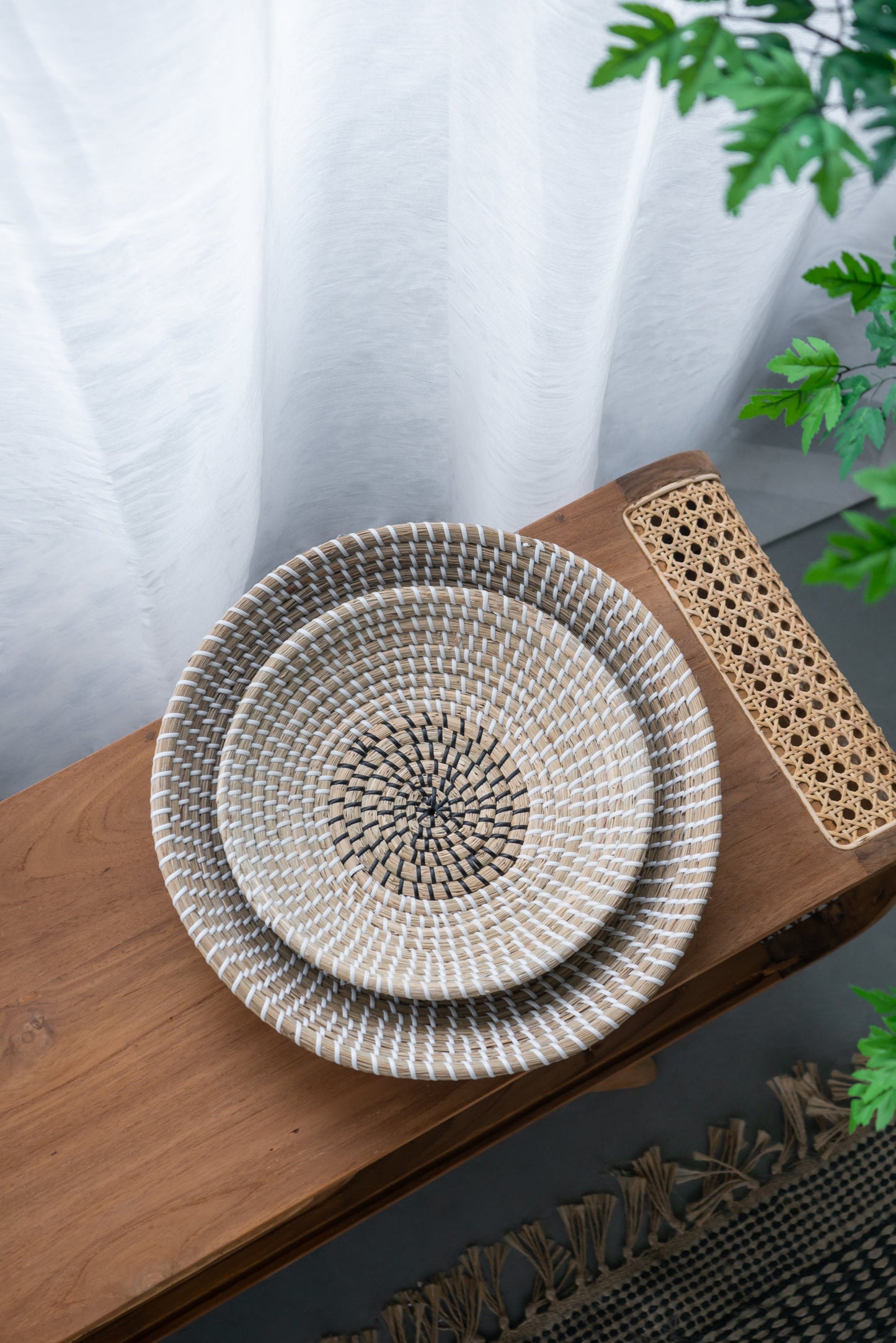 Handwoven two tone seagrass bowls styled on wood table