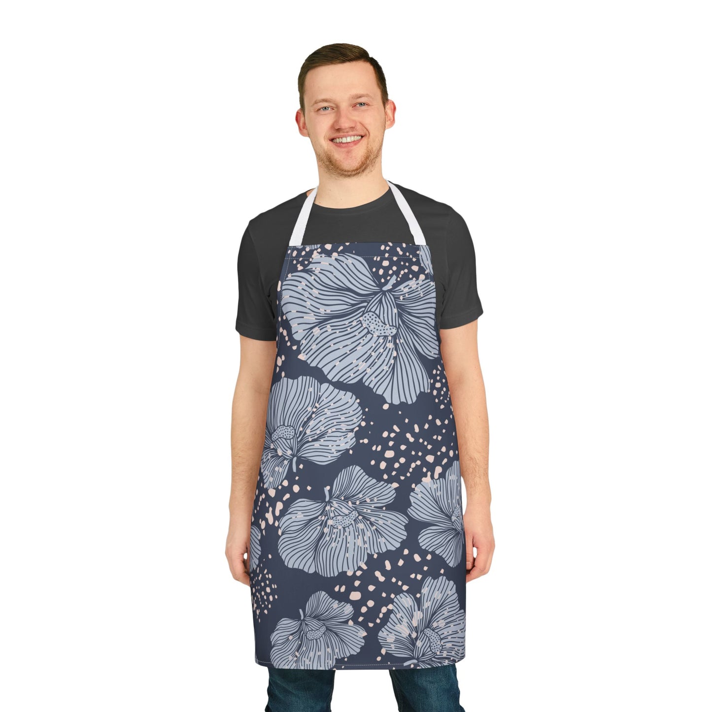 Man wearing a navy apron with floral pattern on a white background