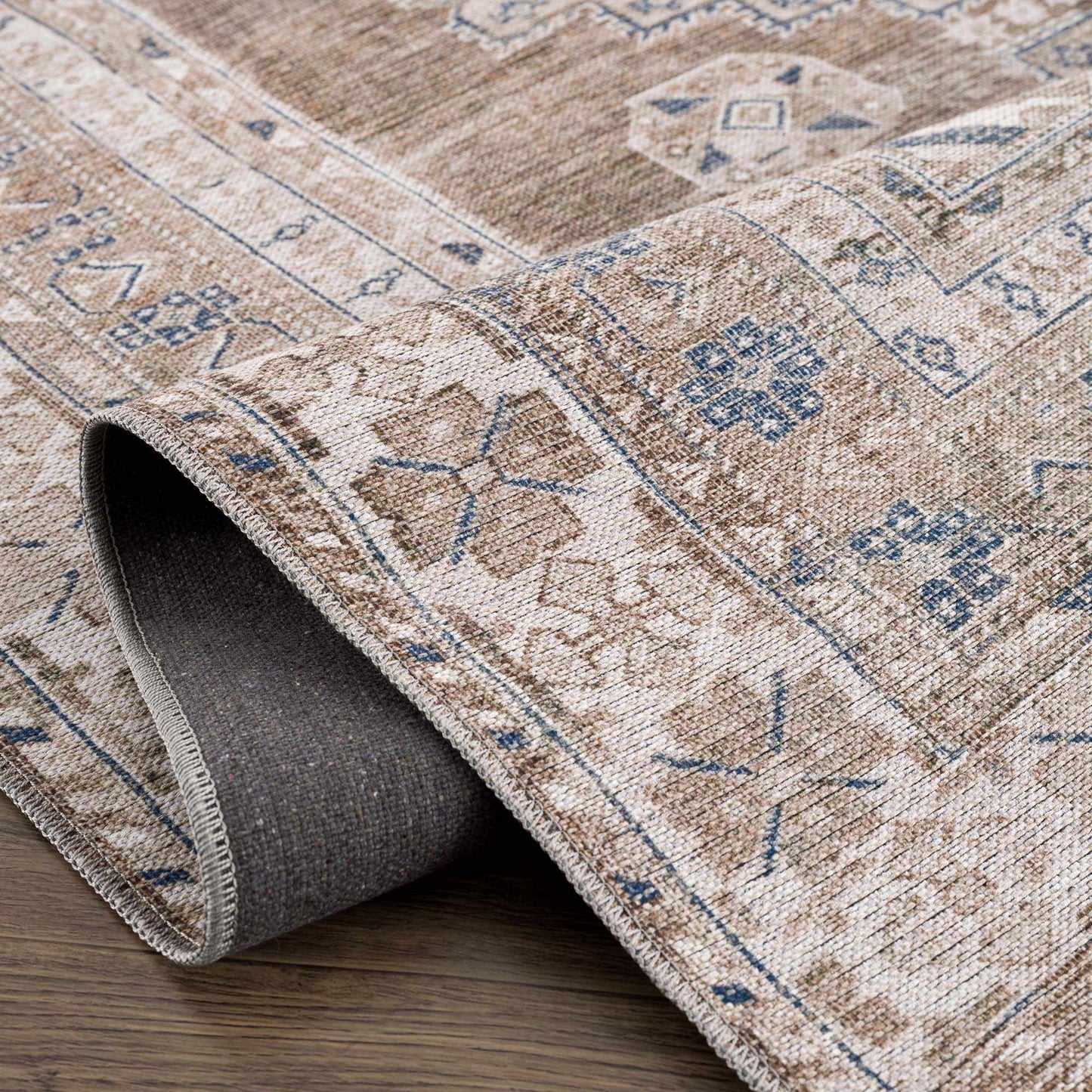 Folded edge of Baltinglass washable rug showing thickness and backing