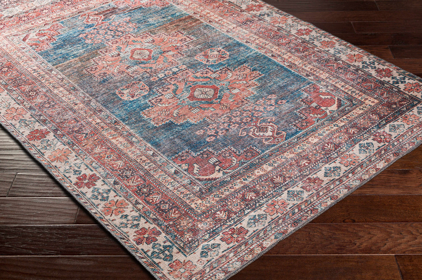 Decorative rug with intricate patterns on a wooden floor