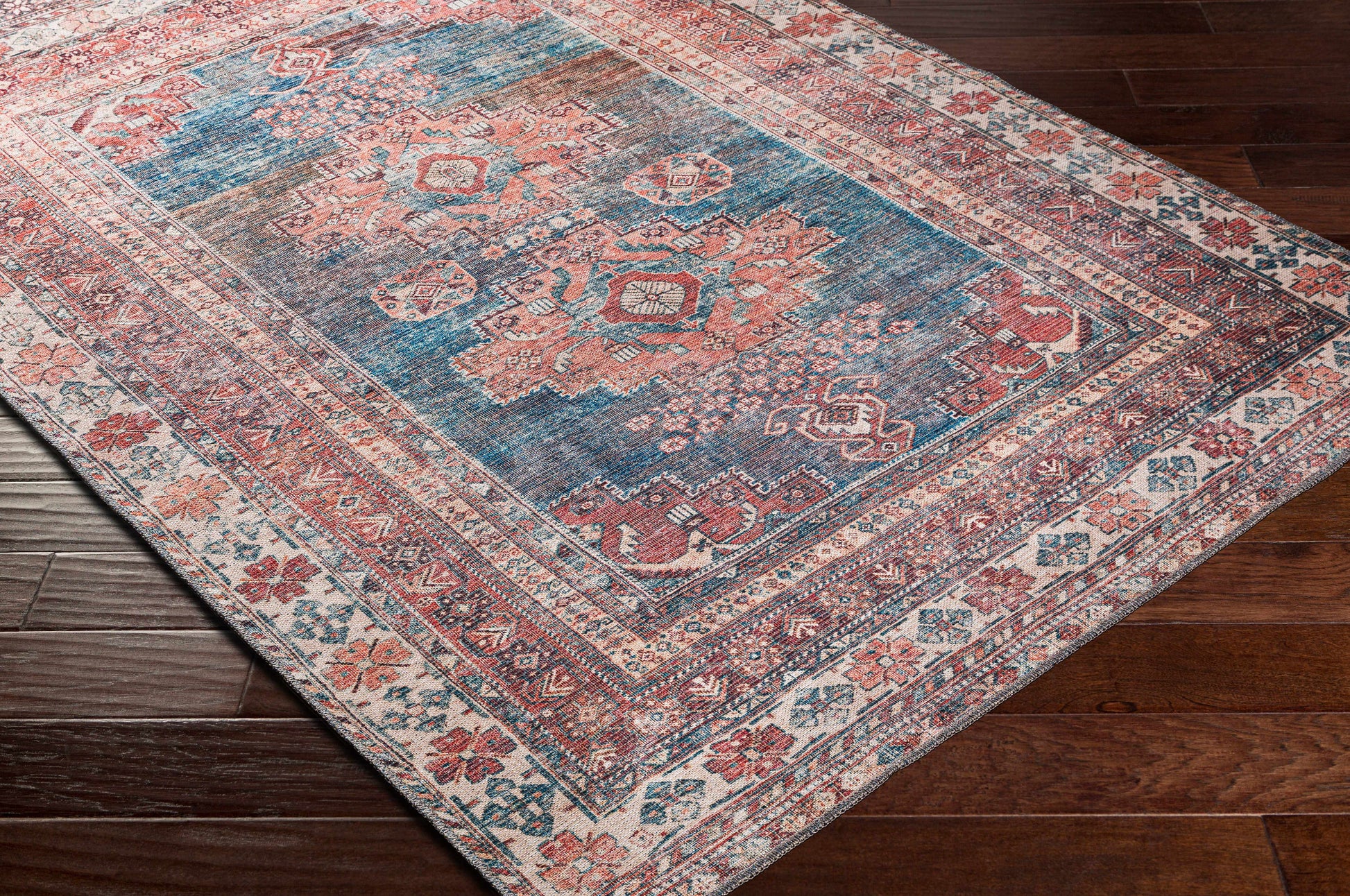 Decorative rug with intricate patterns on a wooden floor