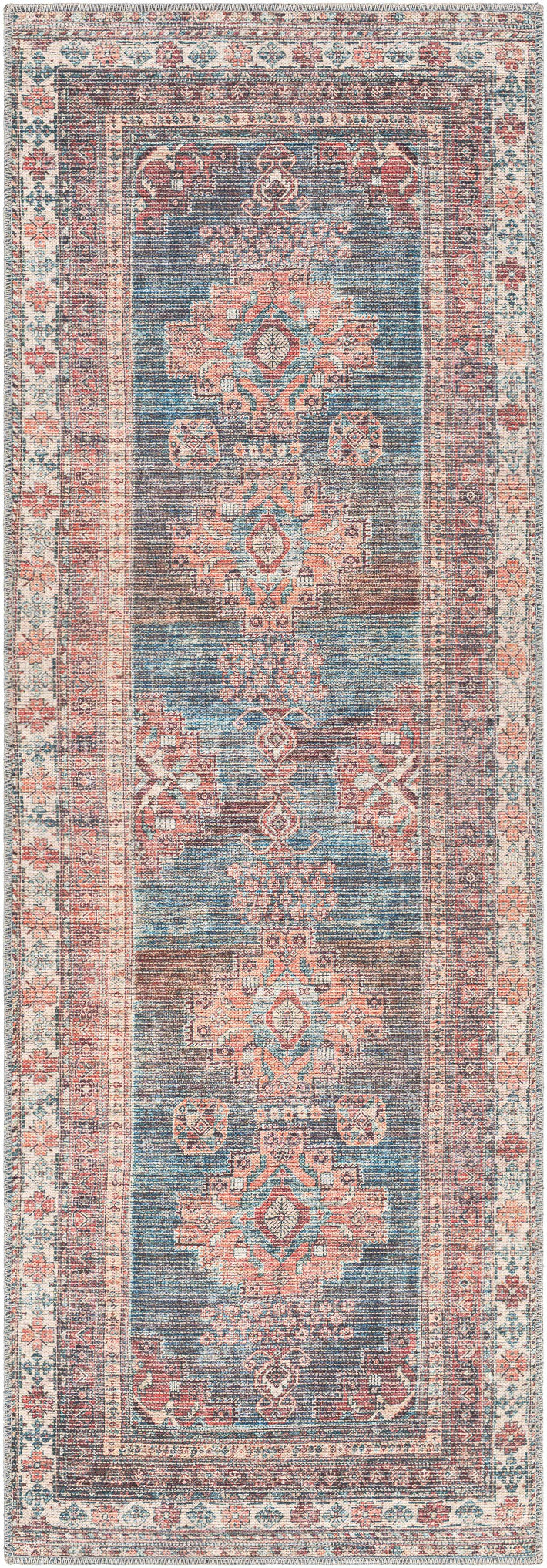 Decorative rug with intricate patterns in blue, pink, and beige on a dark background