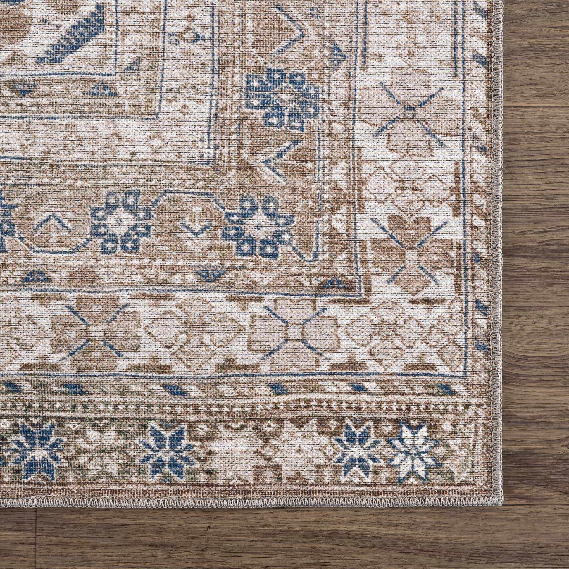 Corner view of Baltinglass low-pile rug with floral border design