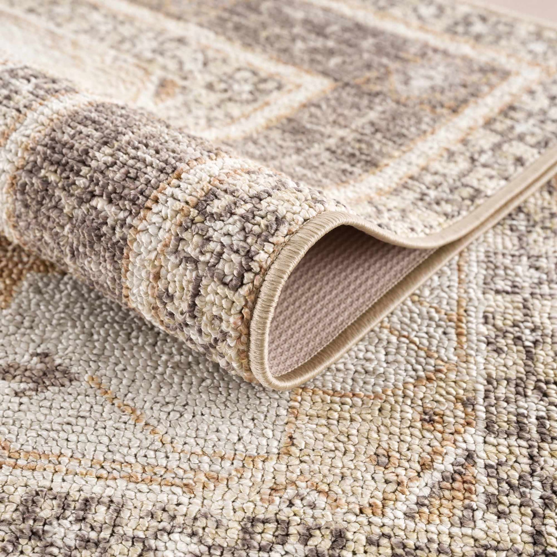 Close-up of a textured beige and brown area rug with a geometric pattern.