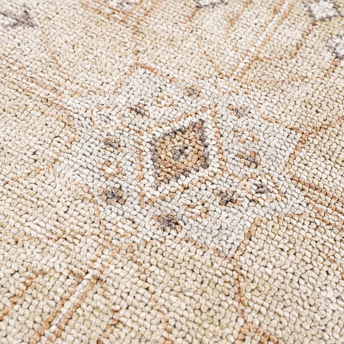 Close-up of a textured beige carpet with a subtle pattern