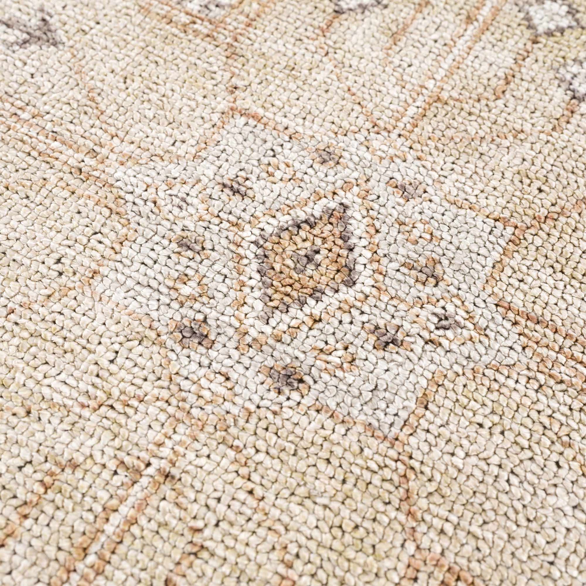 Close-up of a textured beige carpet with a subtle pattern