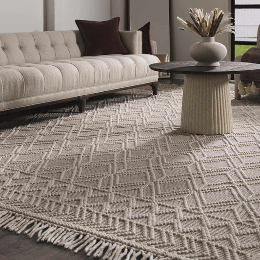 Living room with a patterned rug, sofa, and decorative table.
