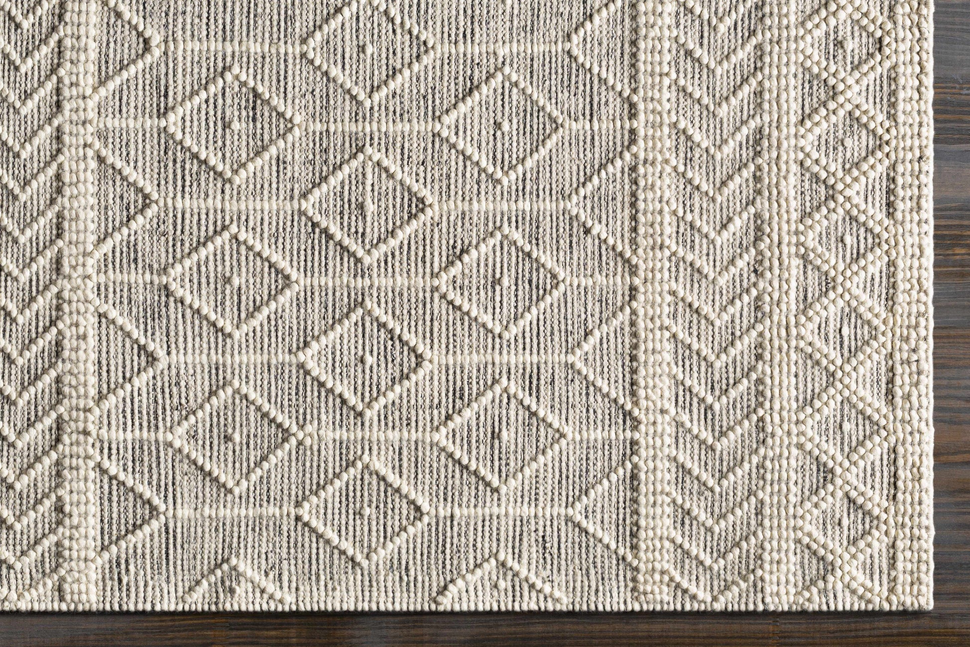 Textured area rug with geometric pattern on a wooden floor