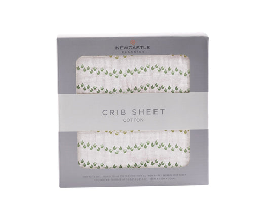 Dino Feet cotton crib sheet close-up showing packaging and pattern