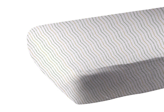 Fitted Dino Feet cotton crib sheet on standard crib mattress