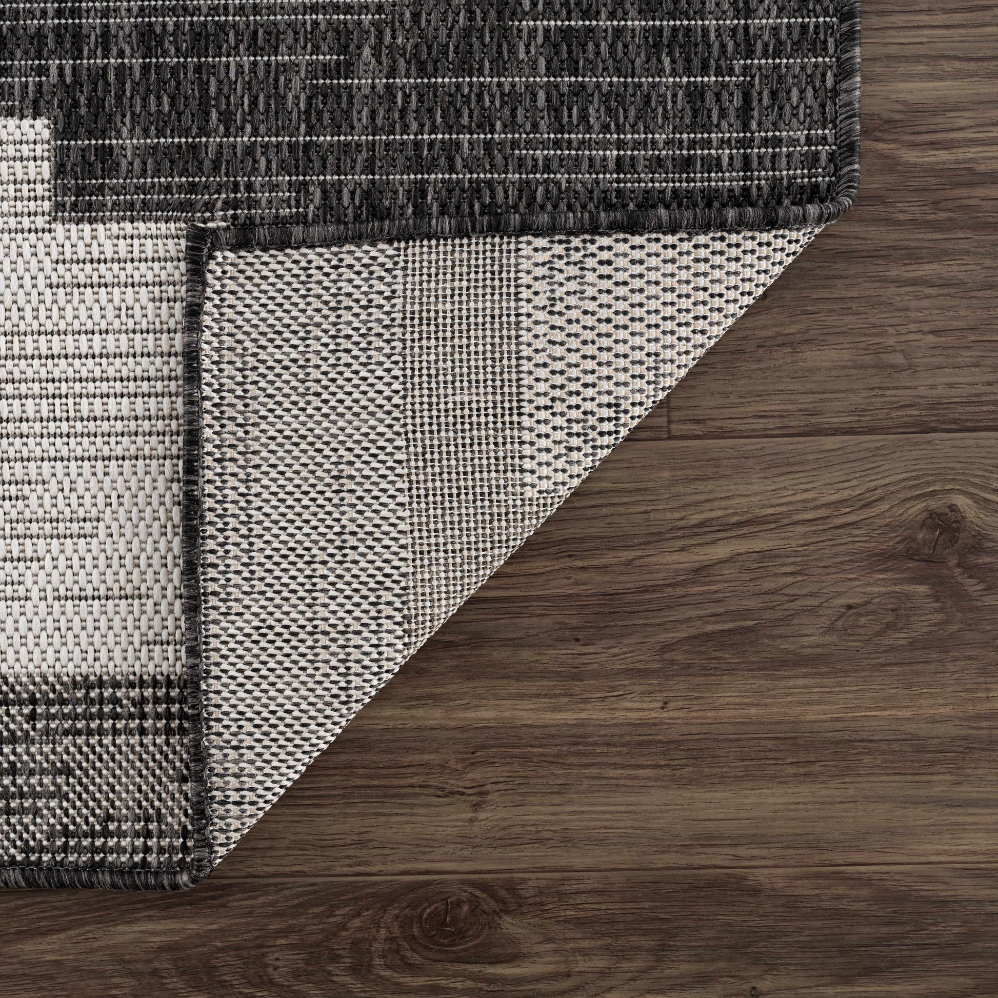 Close-up of a patterned rug on a wooden floor