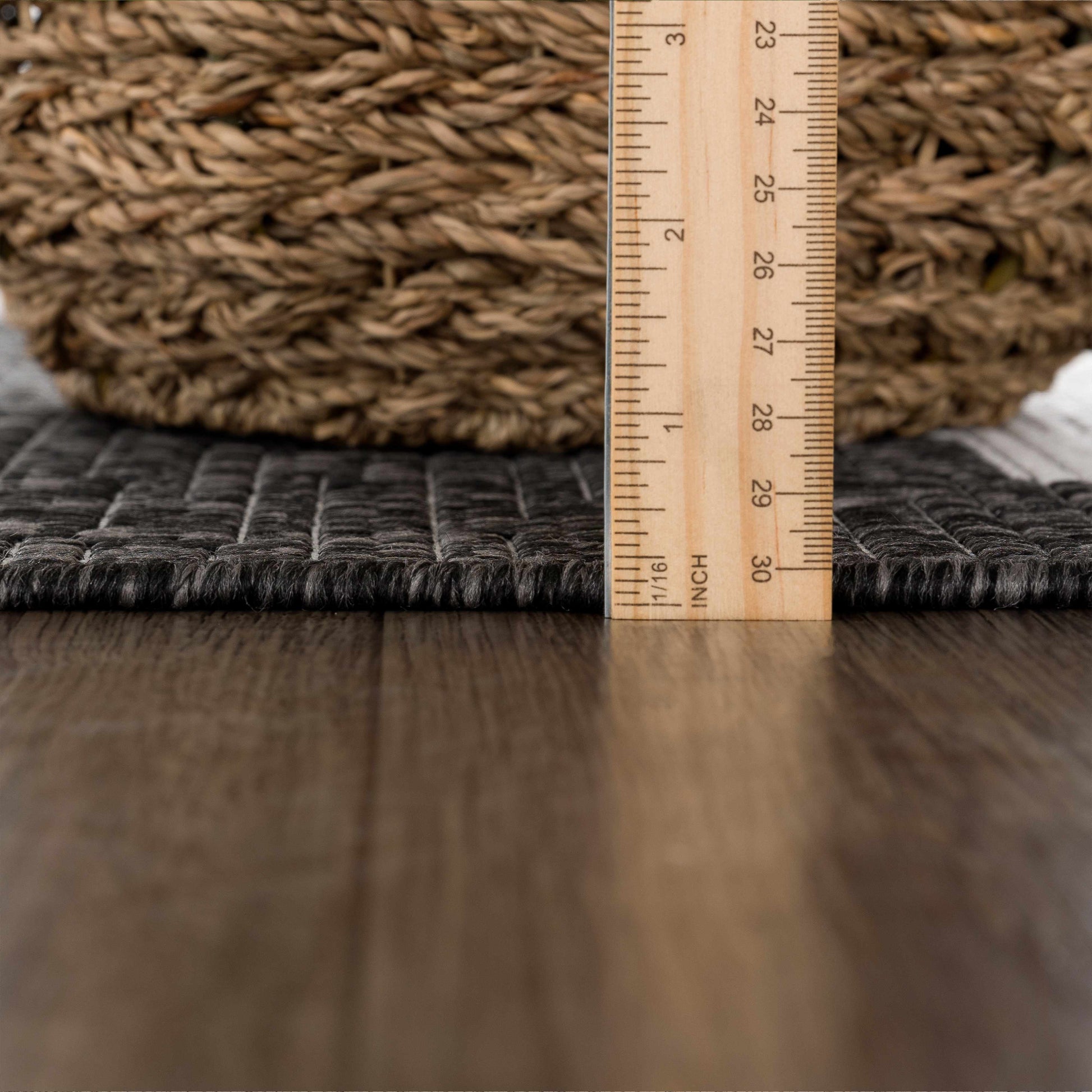 Wooden measuring ruler on a textured surface with a woven object