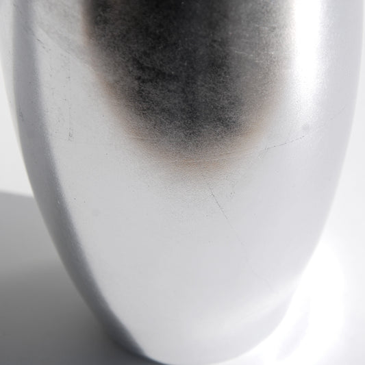 Contemporary silver flower vase with artisanal detailing close-up

