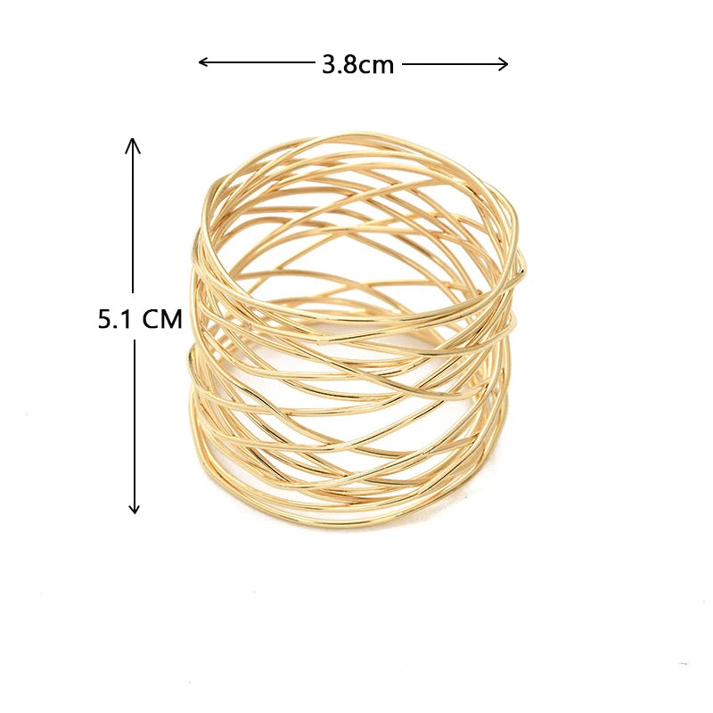 Gold wire napkin ring with measurements on a white background