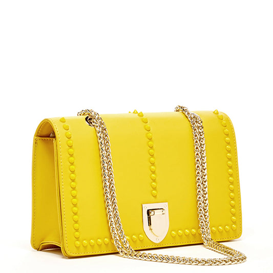 Mustard yellow leather purse with gold chain strap and studded flap - side view
