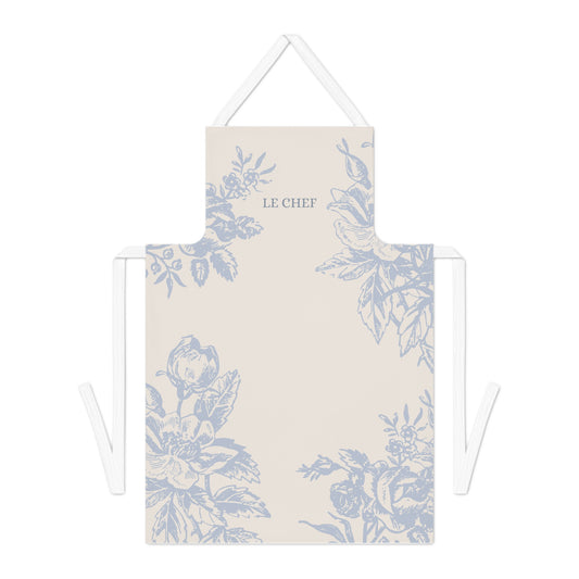 Le Chef blue floral kitchen apron with a soft cream background, featuring durable cotton fabric, a tie-back closure, and a stylish one-sided print.