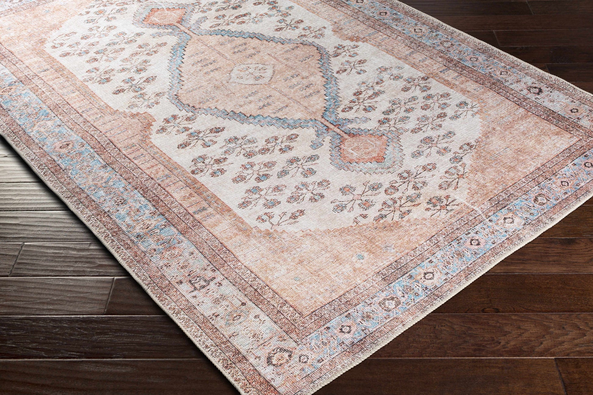 Close-up of Moora washable rug corner with medallion border pattern