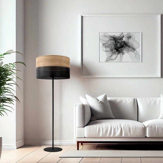 Modern living room with a white sofa, floor lamp, and abstract art on the wall.