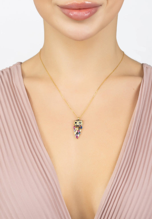 Necklace with a colorful pendant worn by a person in a pink top.