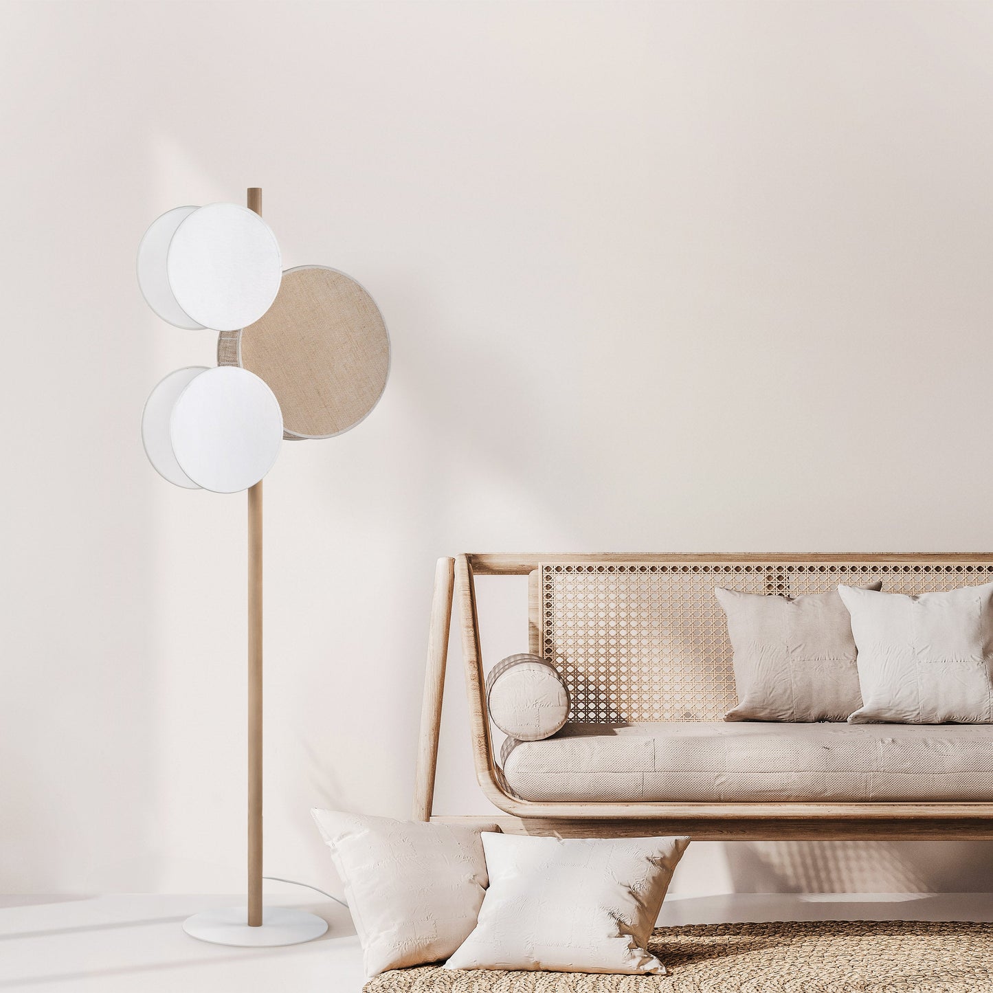 Modern living room with a floor lamp and a sofa against a light wall.