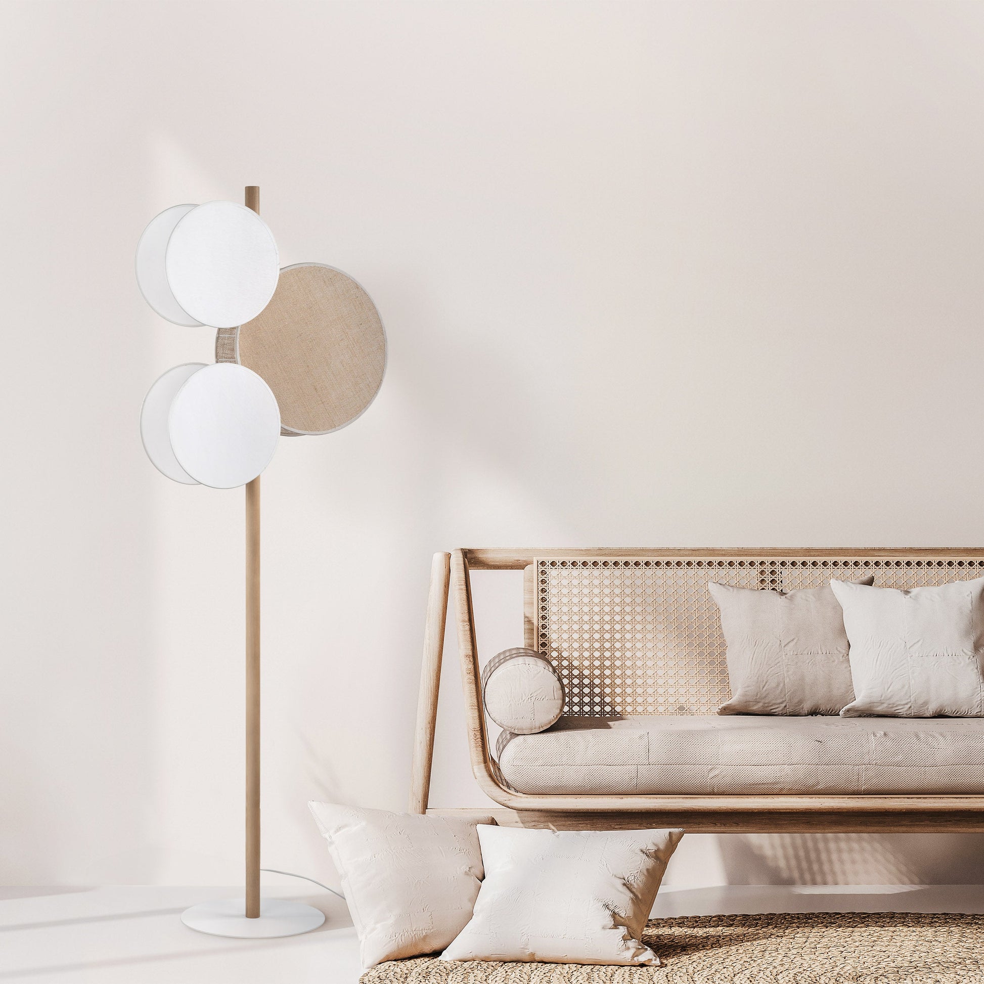Modern living room with a floor lamp and a sofa against a light wall.