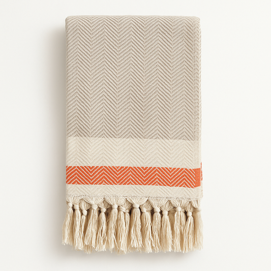  Beige throw blanket with rust stripe and fringe, folded to show chevron weave