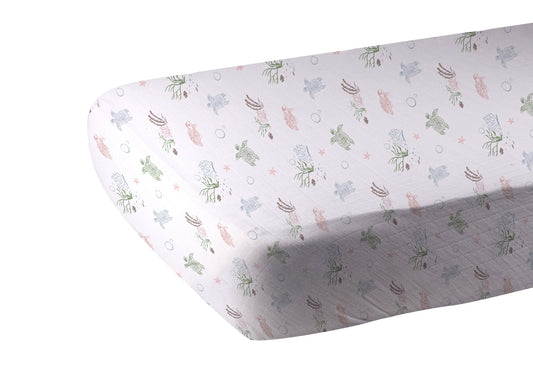 Fitted crib sheet with sea turtles and coral design on mattress