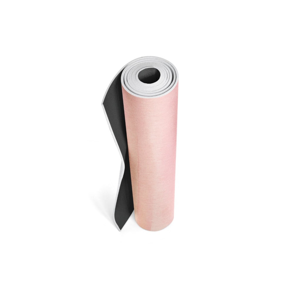 Pink yoga mat rolled up on white background