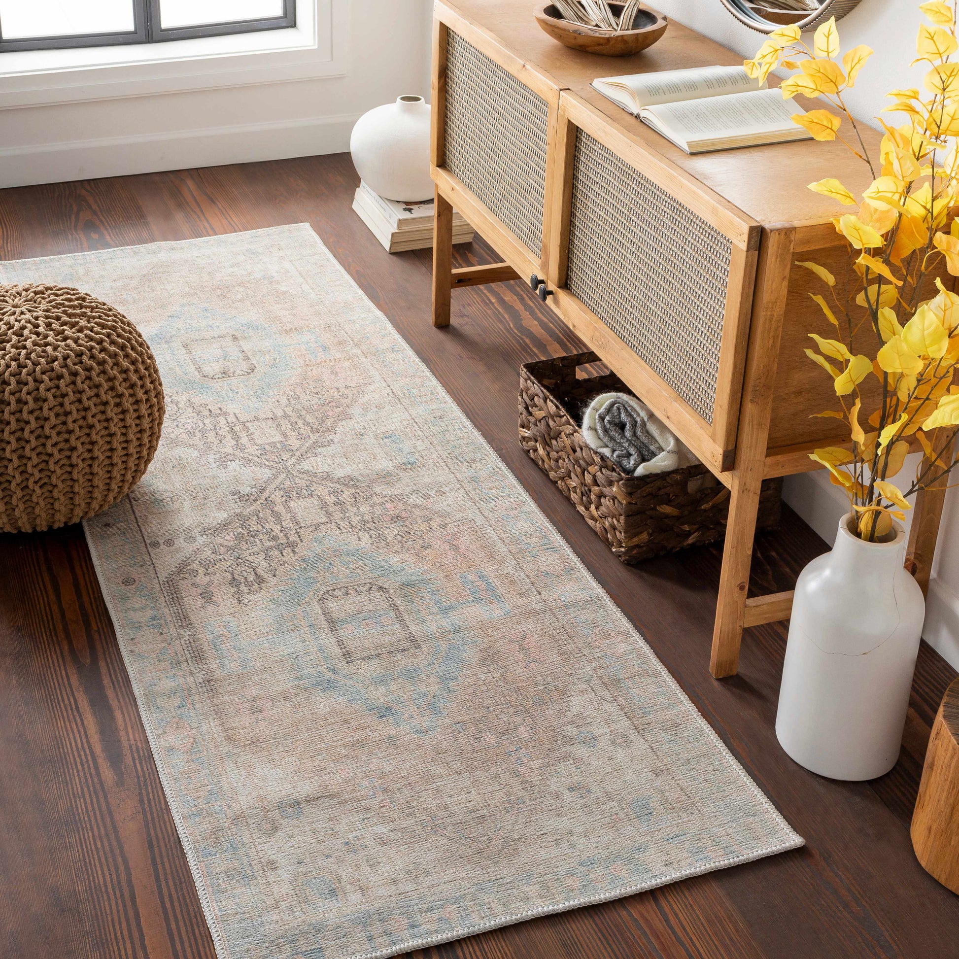 Living room with a wooden console table, rug, and decorative elements.
